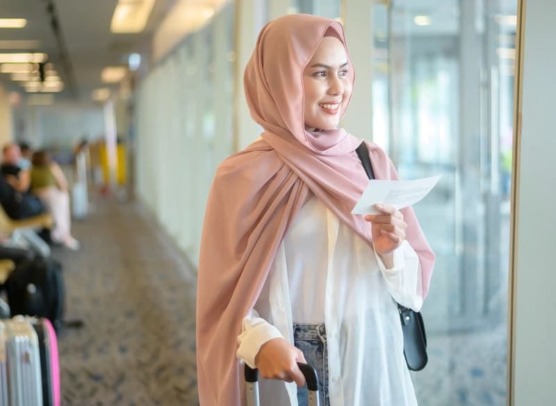 Man working on laptop in airplane